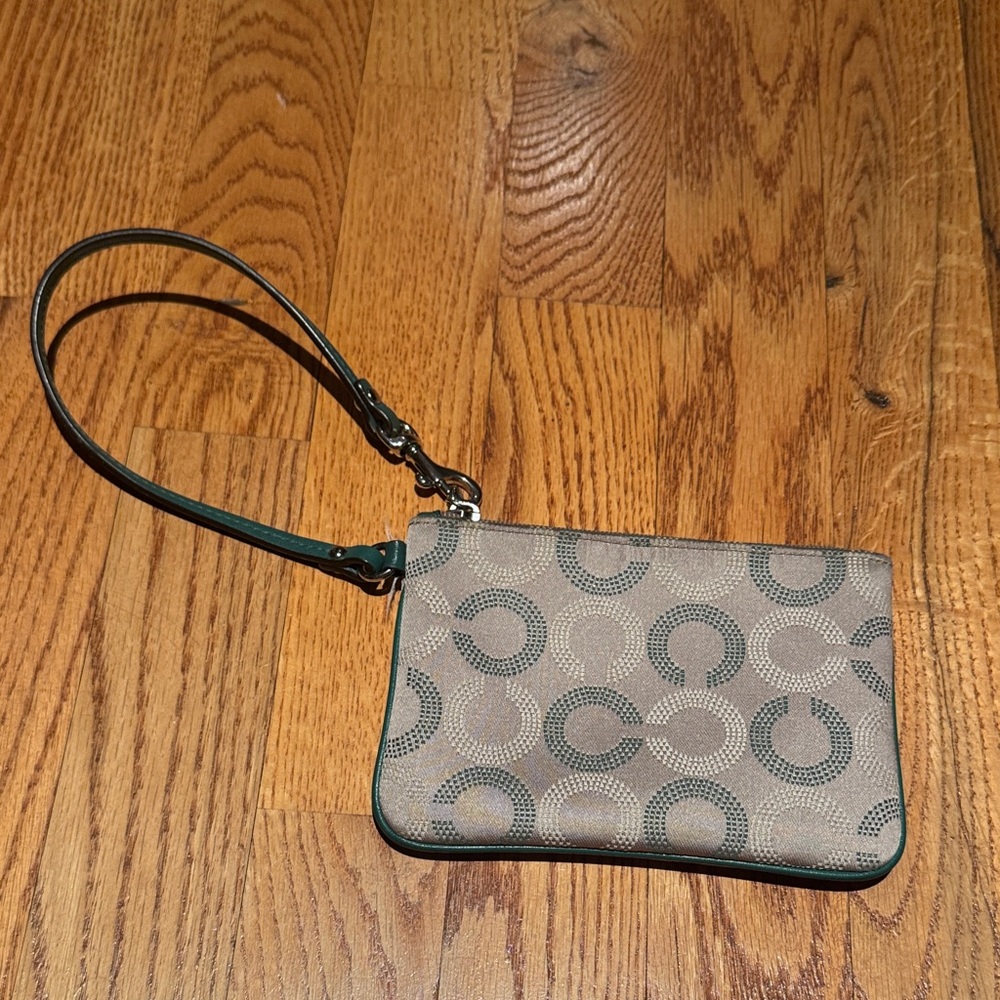 Coach tan and green pattern wristlet with purple inside